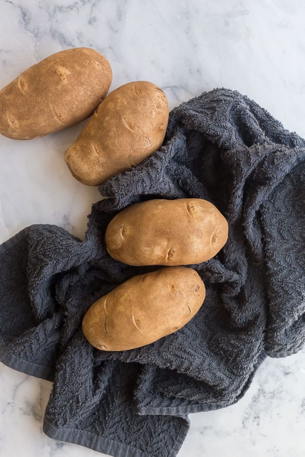 russet potatoes being washed and dried