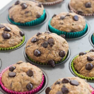 Super moist Banana Chocolate Chip Zucchini Muffins made healthier with whole wheat flour and applesauce! Perfect for that summer zucchini and a great back to school snack! Includes step by step recipe video. | healthy snack recipe | healthy recipe | low calorie | low fat | zucchini recipe | back to school