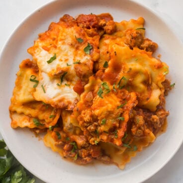 square image of baked ravioli on plate