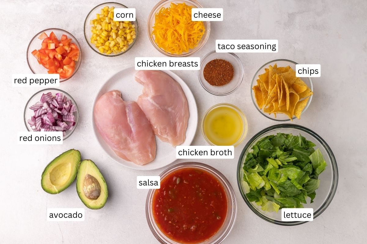 ingredients needed for chicken taco salad in bowls and plate.