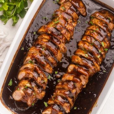 overhead view of dish full of sliced pork tenderloin in honey balsamic sauce.