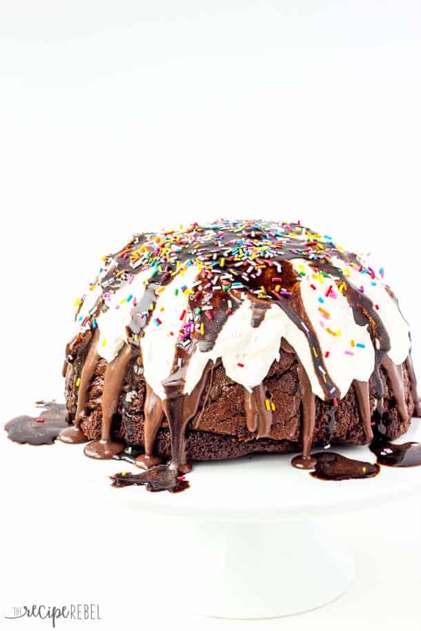 ice cream brownie mountain whole covered in whipped cream chocolate sauce and sprinkles