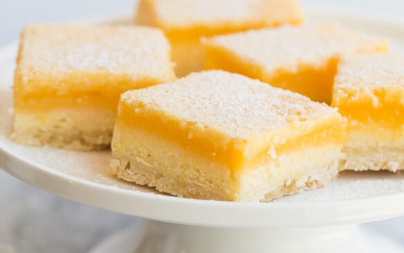 lemon cheesecake bars on white plate