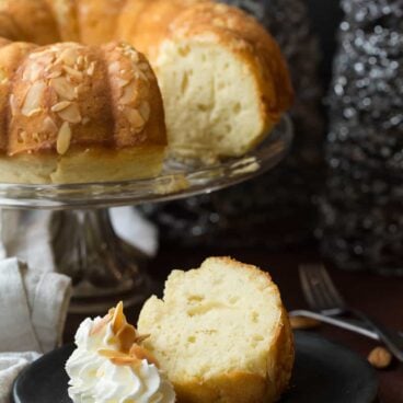A rich, moist Almond Pound Cake that's made better for you with yogurt and reduced sugar! A fun New Years dessert with one whole almond baked in -- whoever gets the almond will have one year good luck!
