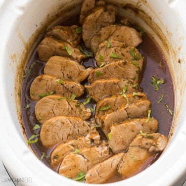 square image of slow cooker pork tenderloin sliced in sauce